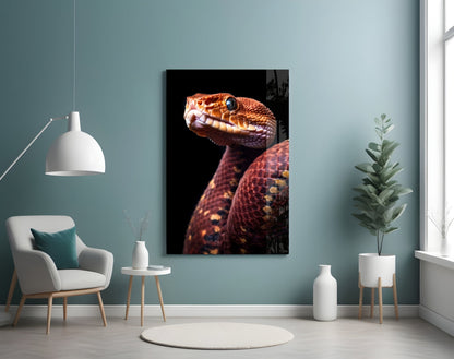 Red Stare Viper glass wall art mounted on teal wall above white chair, displaying orange-red snake with open mouth against black background.