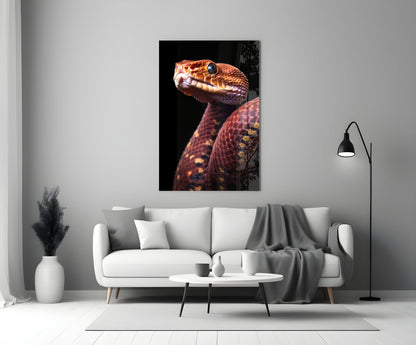Red and orange viper with open mouth displayed on black glass panel mounted above white sofa in modern living room.