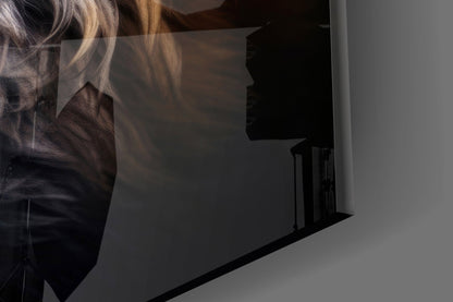 Close-up side view of glass wall art showing a fox's profile with golden and dark tones against a white wall.