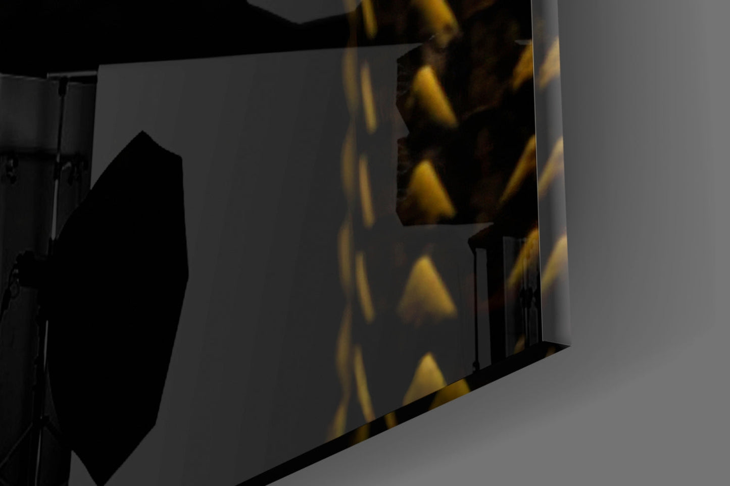Close-up angled view of black and yellow geometric viper glass wall art with triangular patterns and reflective surfaces.