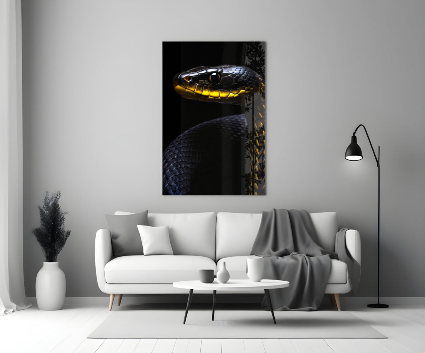 Black and yellow viper glass wall art mounted above white sofa in minimalist living room setting.