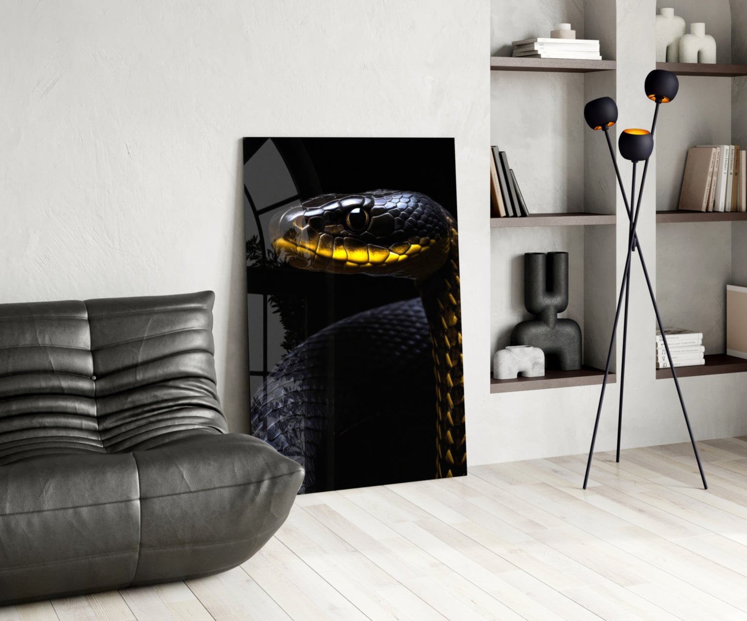 Black and yellow viper glass wall art displayed in modern living room beside grey leather chair and shelving unit.