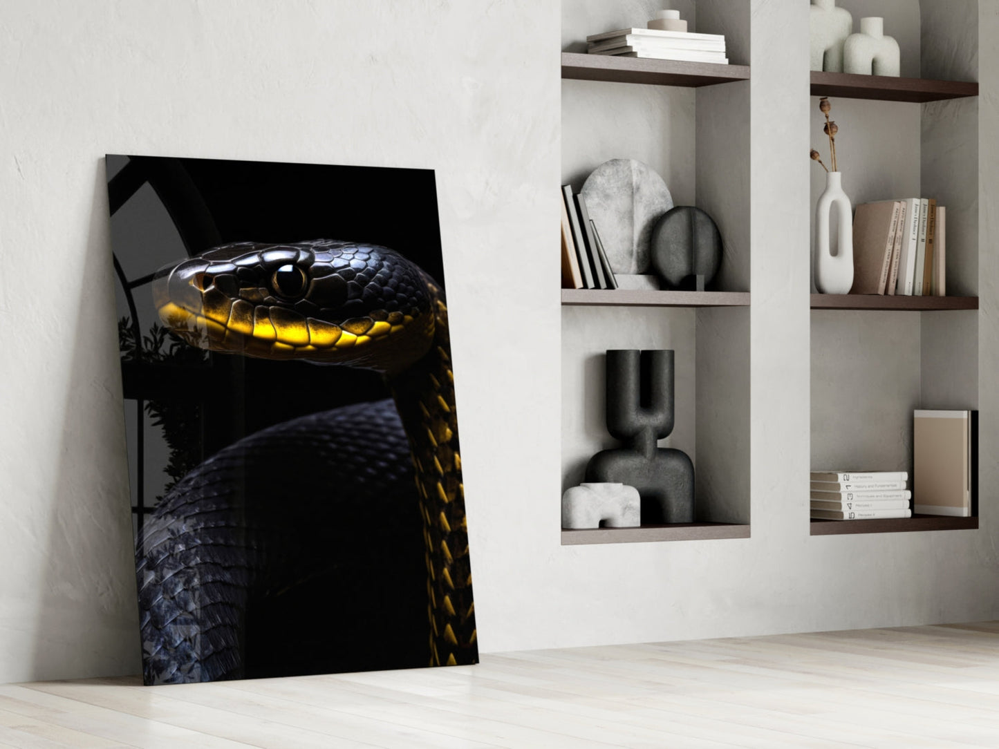 Black and yellow viper glass wall art leaning against white wall beside shelving unit displaying decorative objects and books.