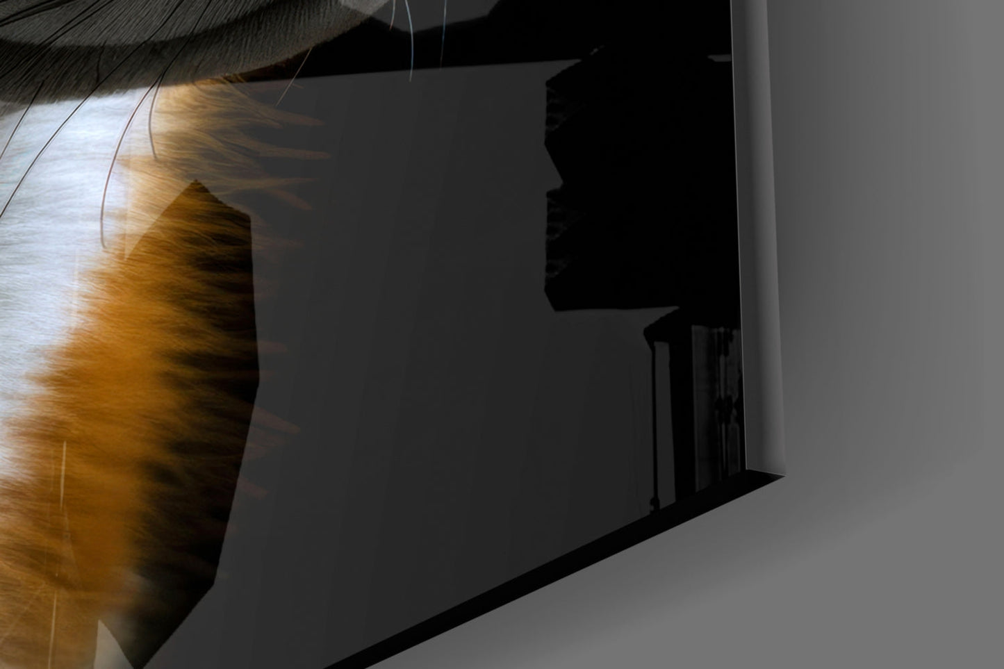 Close-up angled view of golden-hued fox glass art with black silhouette shadow cast on white wall beside staircase.