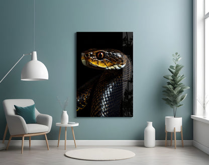 Golden-eyed black snake glass wall art displayed on a pale blue wall above a white chair and potted plant.