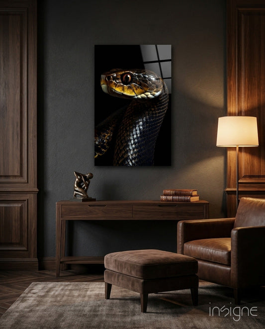 Golden-eyed black snake glass wall art displayed above wooden console table in modern interior setting.
