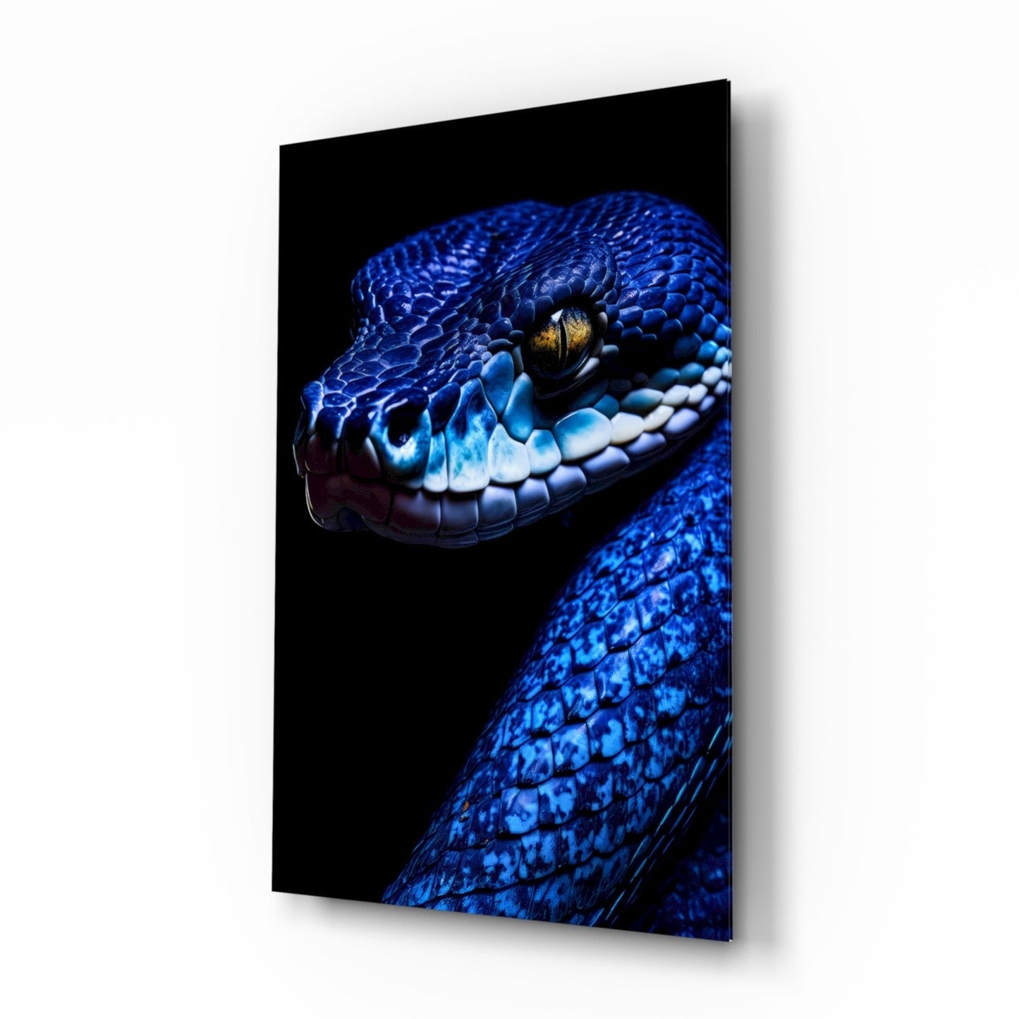 Blue viper glass wall art displayed at an angle, showing a vibrant blue snake's head with golden eye and white mouth scales against black background.