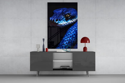 Blue viper glass wall art displayed above gray media console in modern living room setting with red accents.