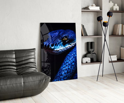 Blue viper glass wall art displayed in modern living room with gray sofa, shelving, and decorative accessories.