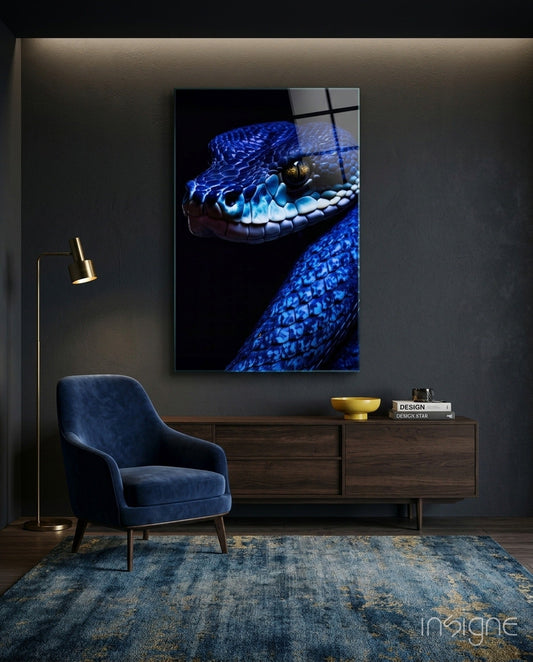 Blue viper glass wall art displayed above wooden credenza in modern interior with navy chair and brass floor lamp.