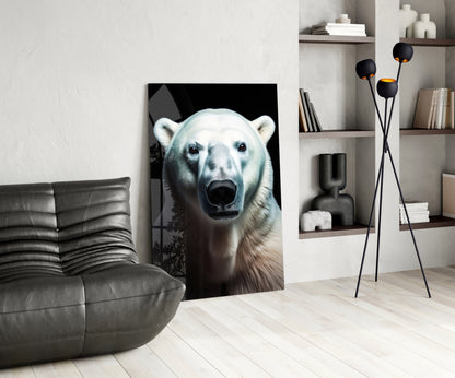 Polar bear glass wall art displaying a close-up frontal portrait against black background, leaning against a gray leather chair in a modern living room setting.