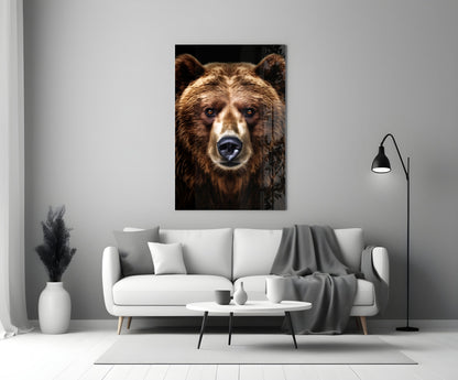 Bear glass wall art displaying close-up brown bear face with white markings against black background, mounted above white sofa in modern living room.