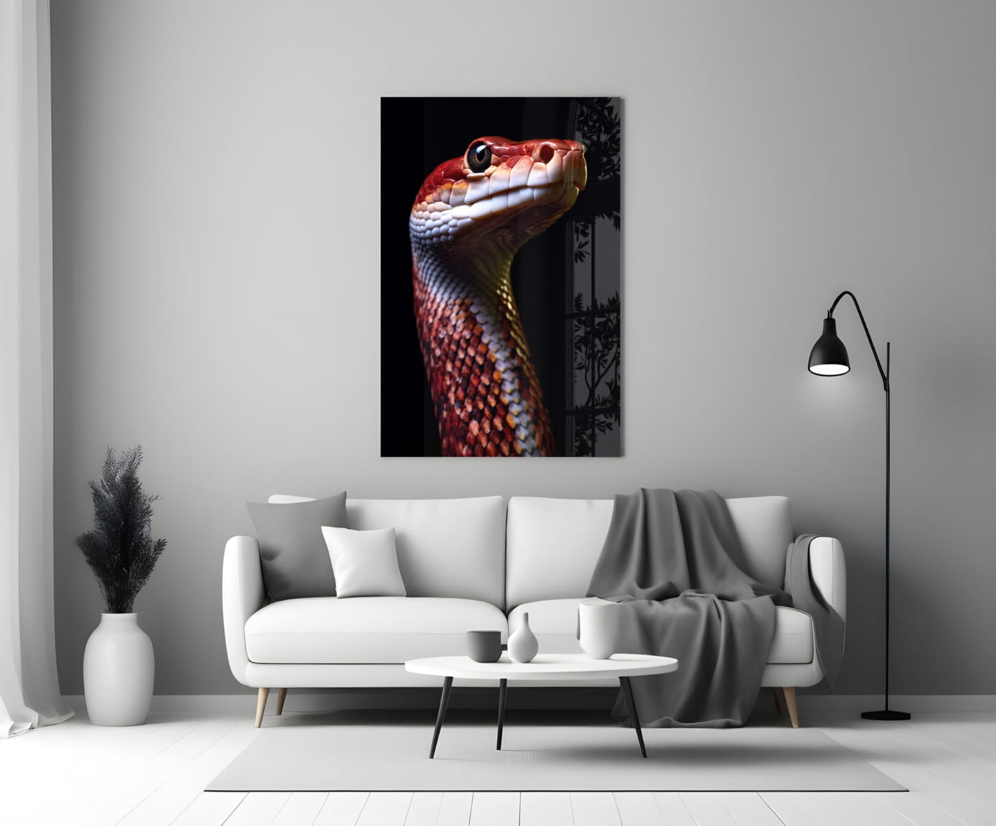Red and white serpent head portrait on black background displayed on living room wall above white sofa.