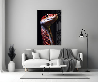 Red and white serpent head portrait on black background displayed on living room wall above white sofa.