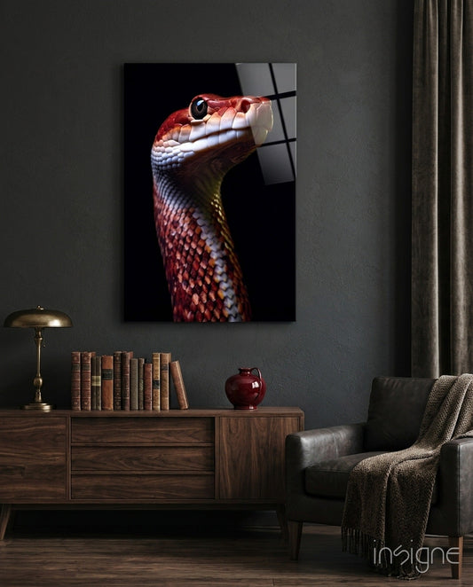 Red and white serpent head in profile against black background, displayed on dark gray wall above wooden cabinet in styled room setting.