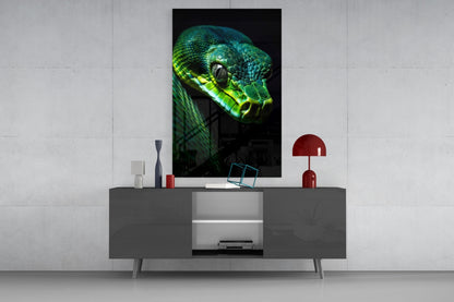 Emerald green viper glass wall art displayed above gray media console in modern interior setting with red accents.
