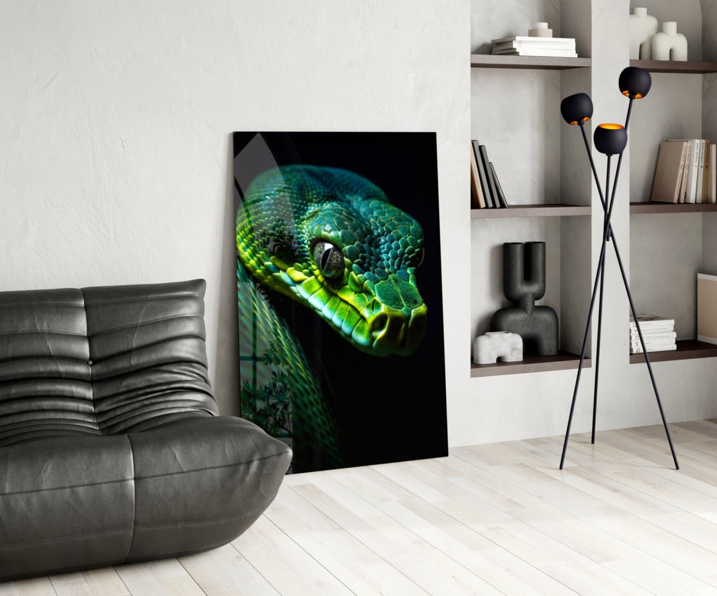 Emerald green viper glass wall art displayed in modern living room with gray leather chair, wooden shelving, and black floor lamp.