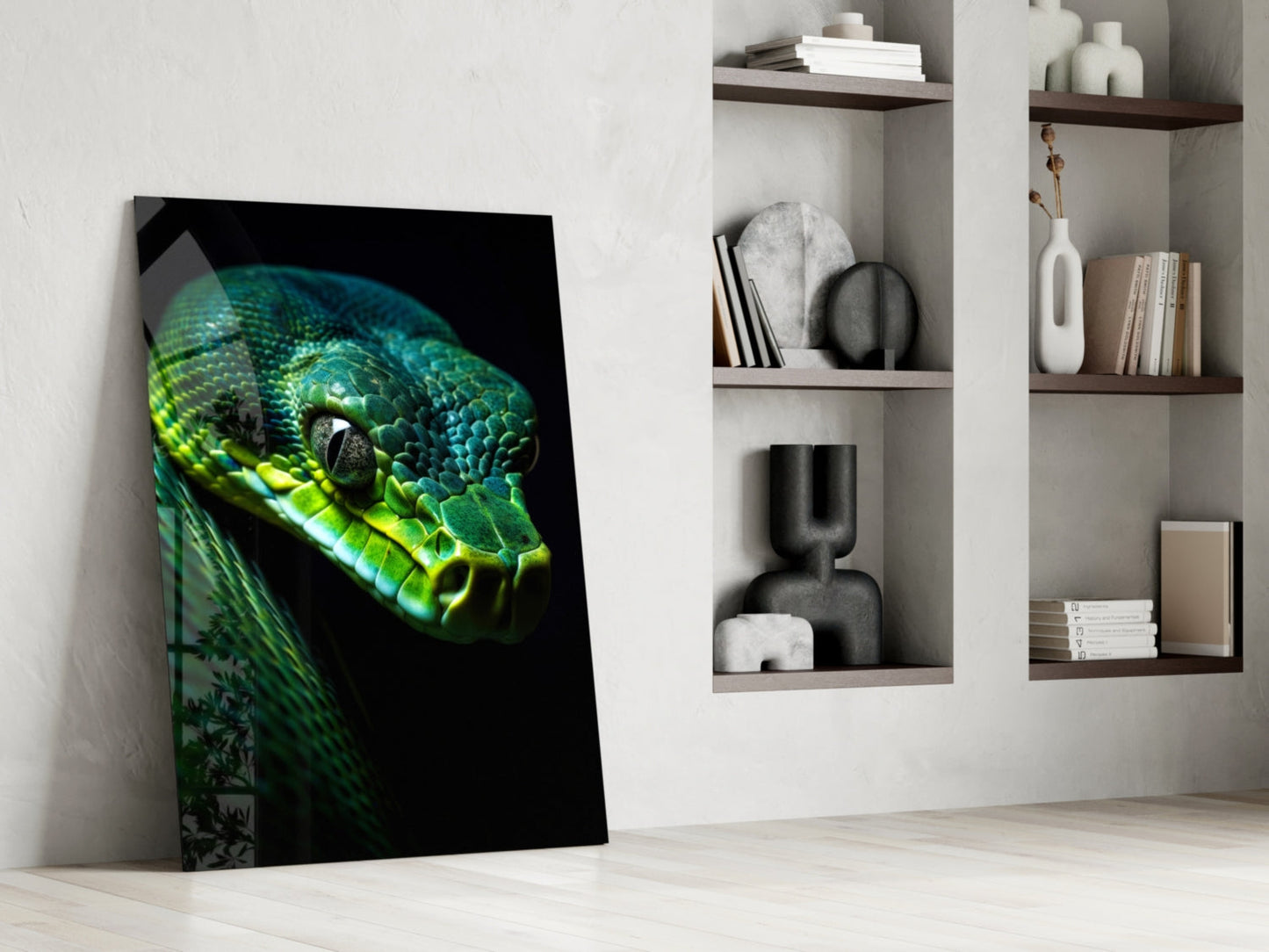 Glass wall art featuring a vibrant emerald green viper's head against black background, leaning against white wall beside wooden shelving.