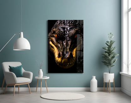 Glass wall art depicting a close-up reptile head with golden-yellow markings against black background, displayed in modern teal room.