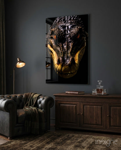 Glass wall art featuring a close-up crocodile face with golden-yellow jaw against dark background, displayed above wooden cabinet in styled interior.