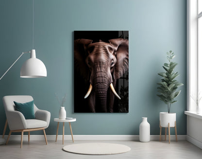 Elephant glass wall art with ivory tusks displayed in a modern room with teal walls, white furniture, and potted plants.