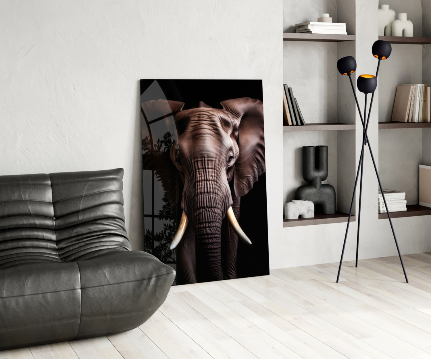 Modern living room interior featuring a large glass wall art of an elephant with ivory tusks against black background, displayed next to a gray leather chair and wooden shelving unit.