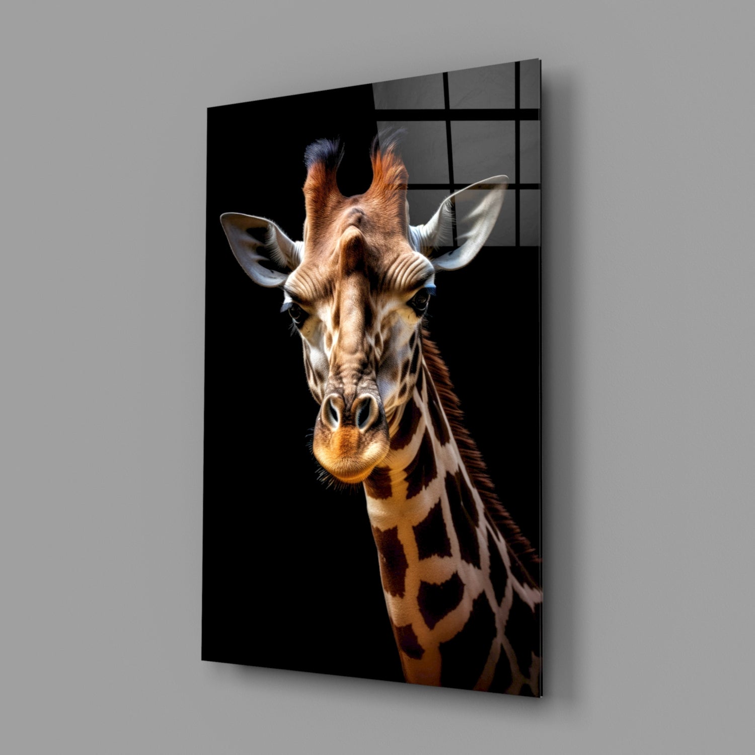 Giraffe glass wall art mounted on gray wall, displaying front-facing giraffe portrait against black background with visible grid pattern on glass surface.