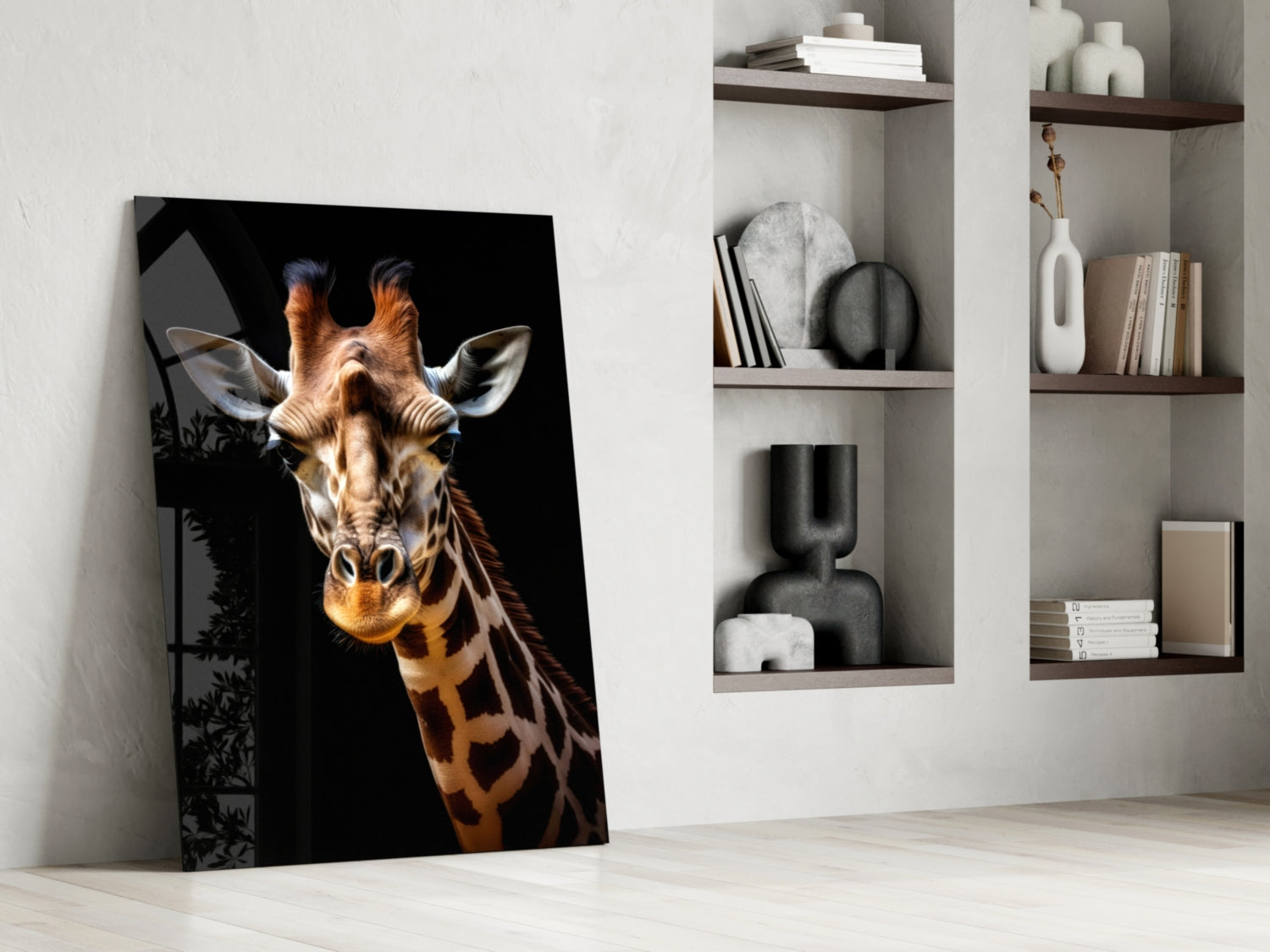Giraffe glass wall art leaning against white wall beside shelving unit displaying books and decorative objects.