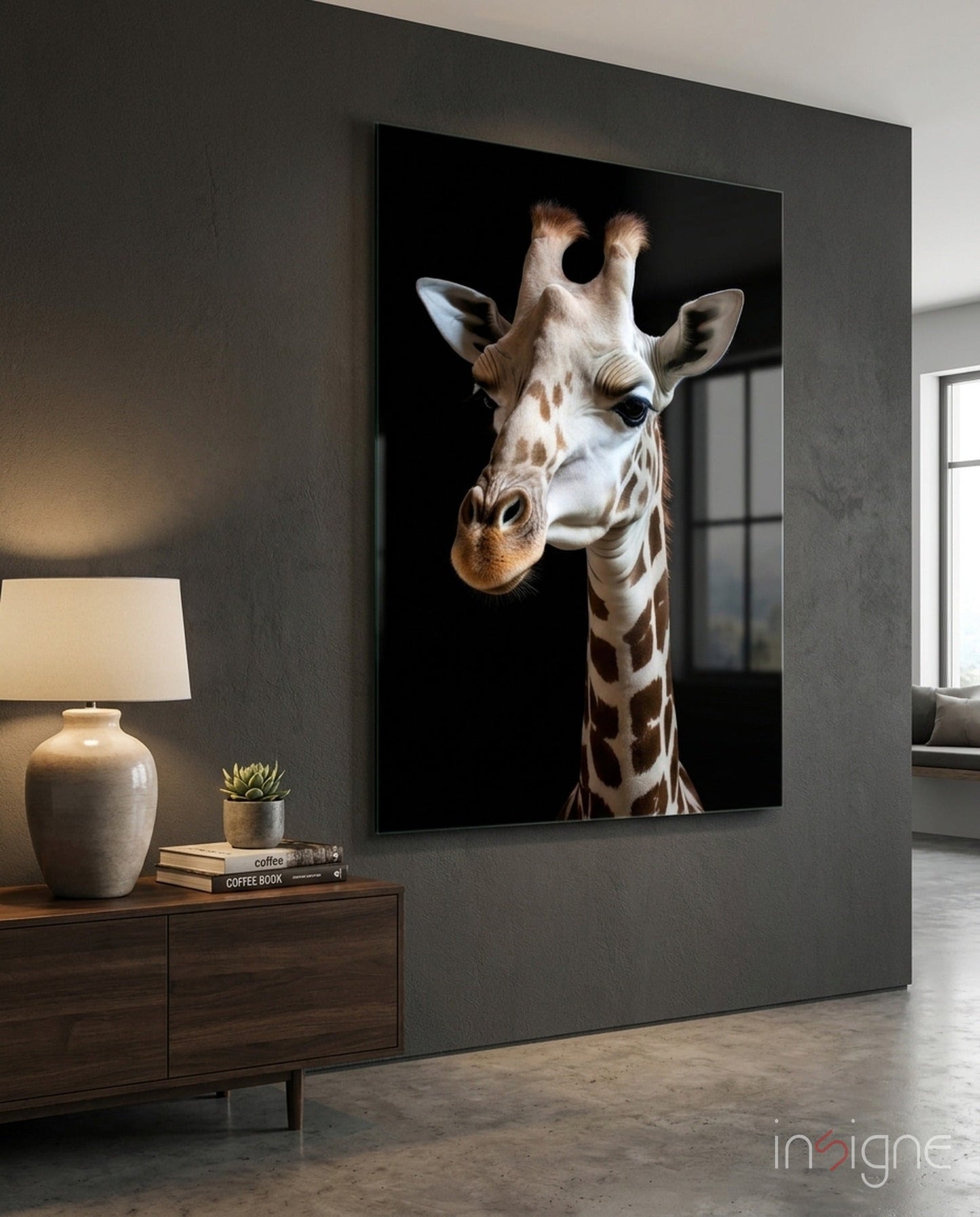 Giraffe portrait glass art mounted on dark gray wall above wooden console table with lamp and décor.