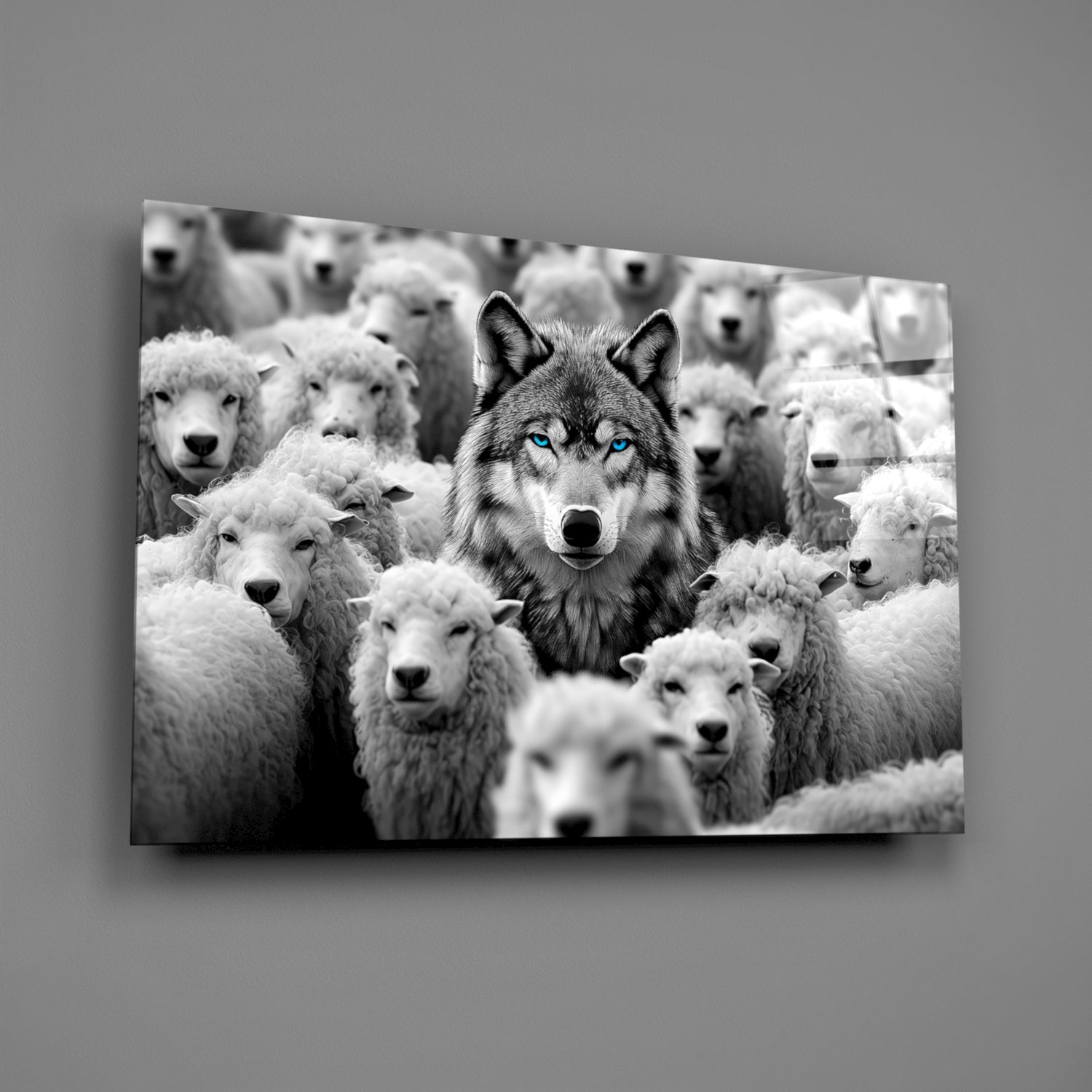 Black and white glass wall art depicting a dark wolf with striking blue eyes surrounded by white sheep in a flock composition.