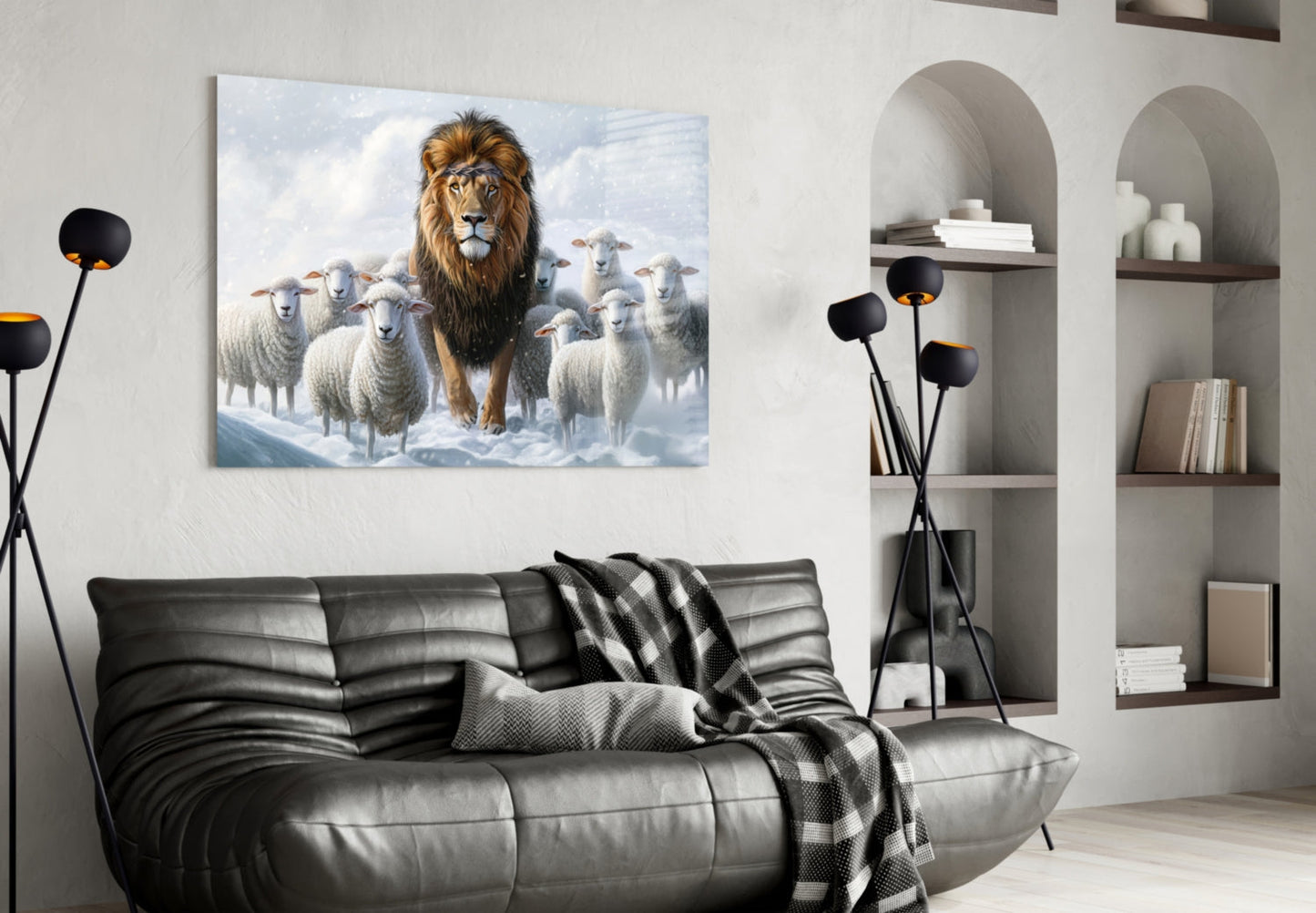 Glass wall art depicting a majestic lion surrounded by white sheep in a snowy landscape, displayed above a black leather sofa in a modern interior.