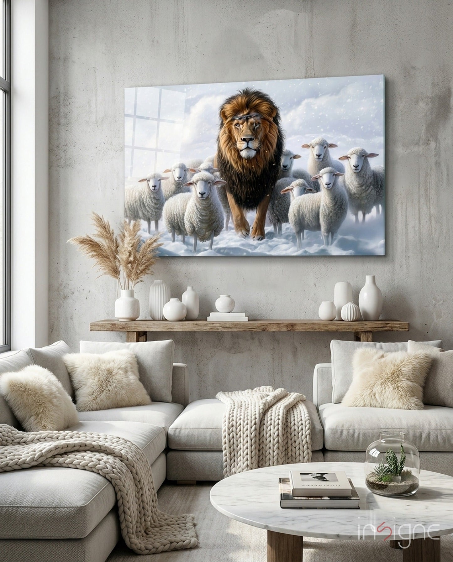 Glass wall art depicting a majestic lion surrounded by white sheep in a snowy landscape, displayed above a wooden shelf in a modern living room.