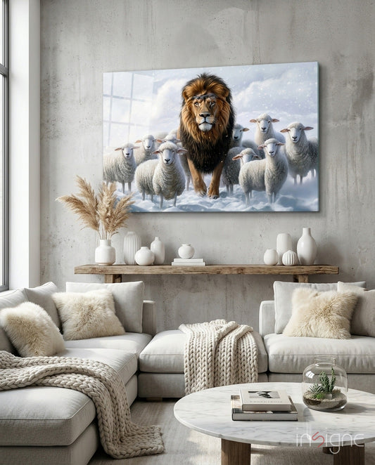 Glass wall art depicting a majestic lion surrounded by white sheep in a snowy landscape, displayed above a wooden shelf in a modern living room.