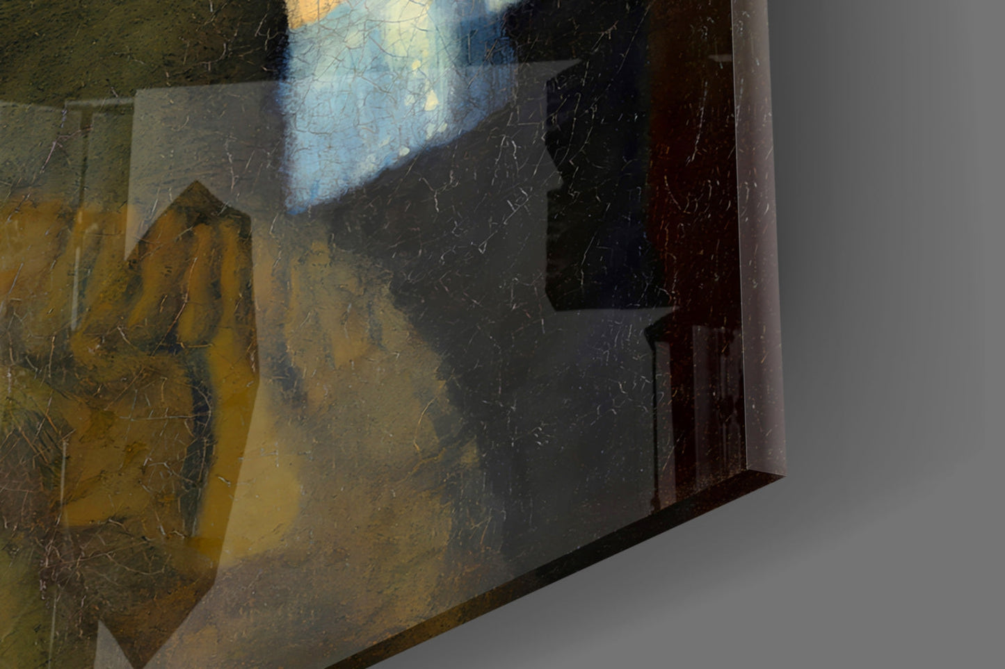 Close-up detail of glass art showing scratched surface texture, yellow and dark tones, with window shadow and edge framing visible.