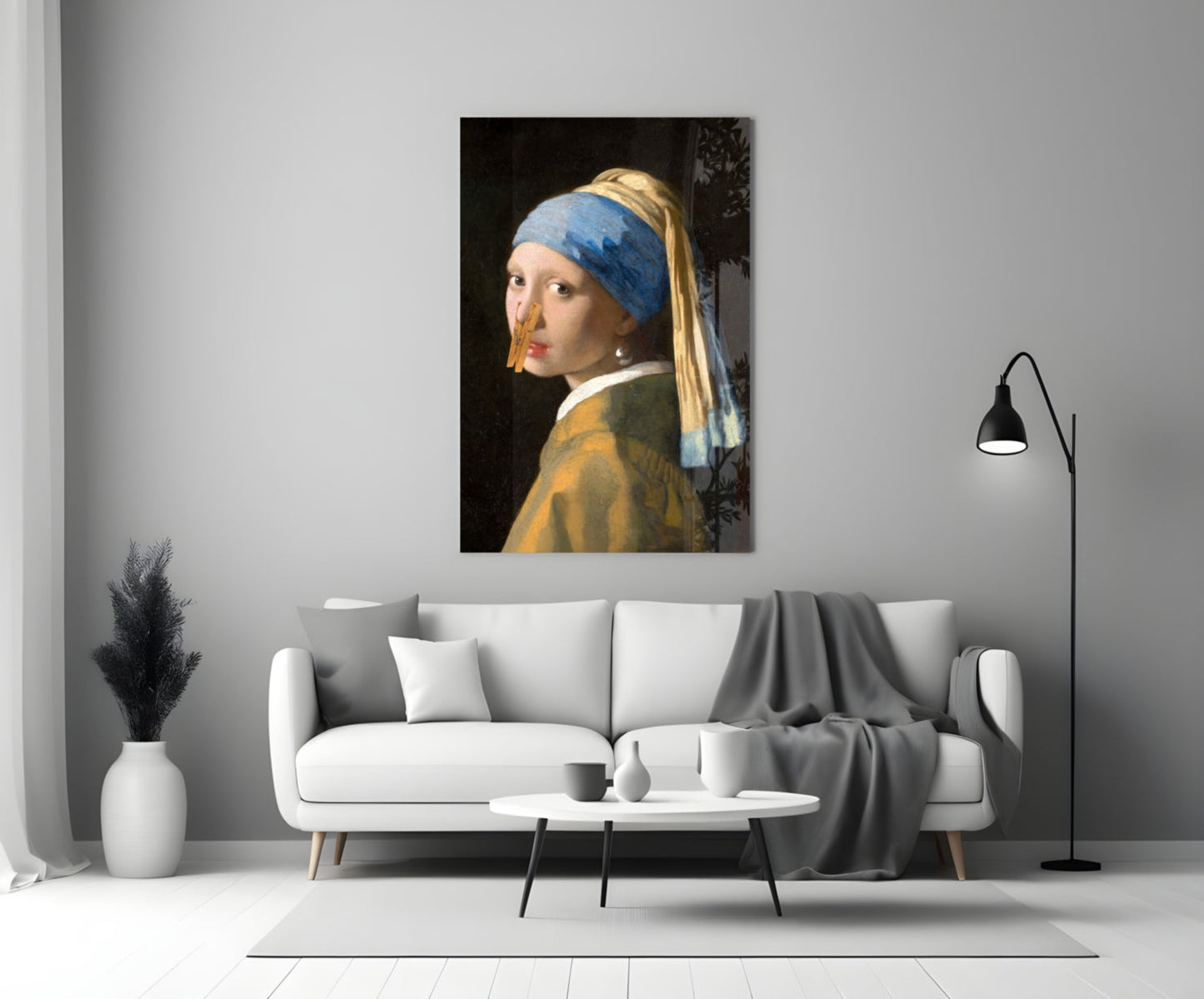 Girl with blue headwrap and gold earring hangs on clothespin glass art above white sofa in modern living room.