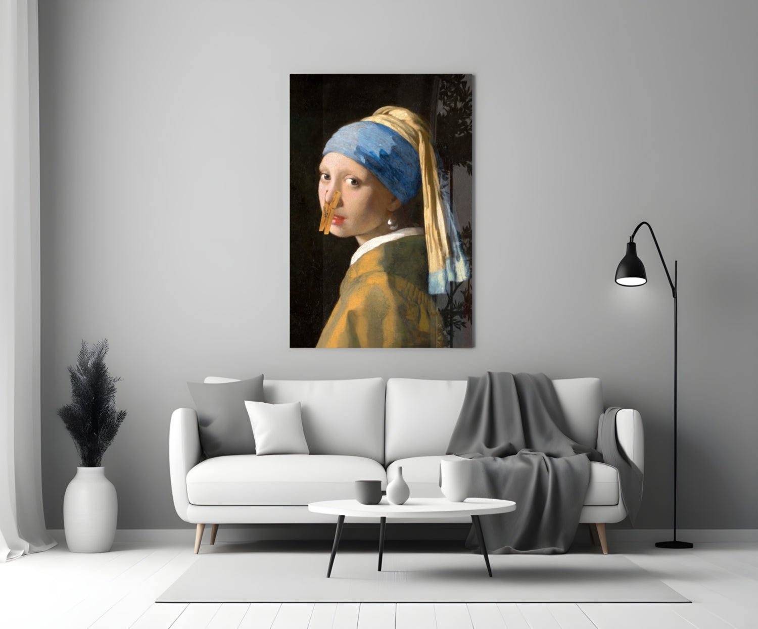 Girl with blue headwrap and gold earring hangs on clothespin glass art above white sofa in modern living room.