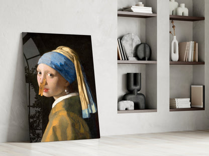 Girl with pearl earring canvas leaning against white wall beside wooden shelves with decorative objects.