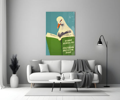 Humorous glass wall art depicting a seagull reading a green book titled "Guano Genius 101: Mastering Precision Poop" against a teal background, displayed above a white sofa in a modern living room.