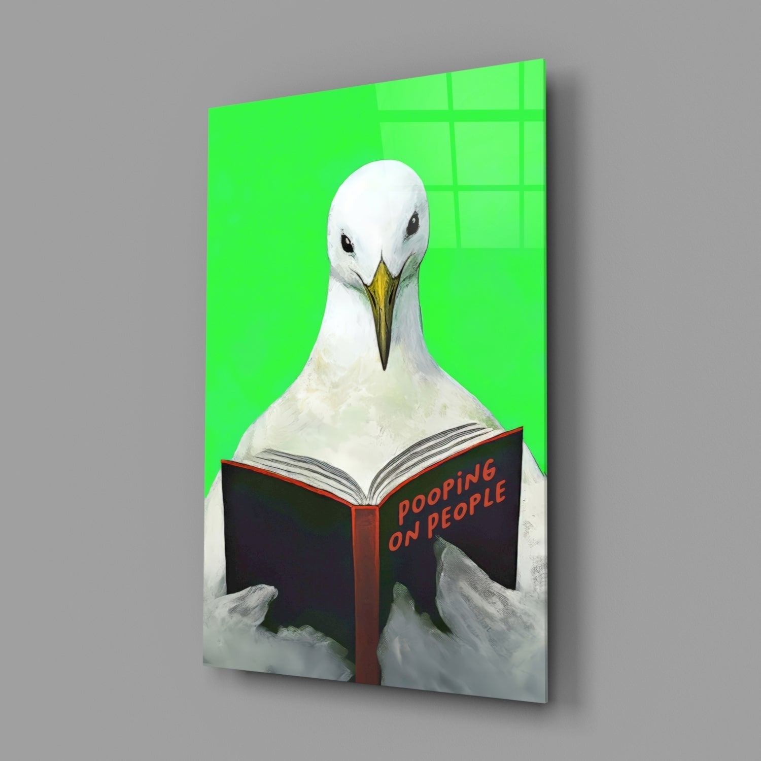 White seagull reading black book titled "Pooping on People" against bright green background on glass wall art panel.