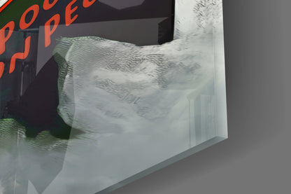 Close-up angled view of frosted glass wall art with etched wavy texture pattern and green-tinted edge detail against gray background.