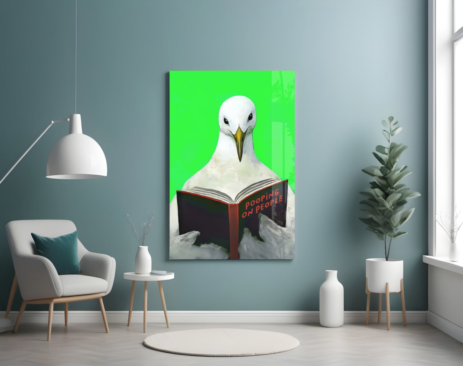 Glass art panel showing a white seagull reading a red book titled "Pooping on People" against a bright green background, displayed on a teal wall in a modern living room.