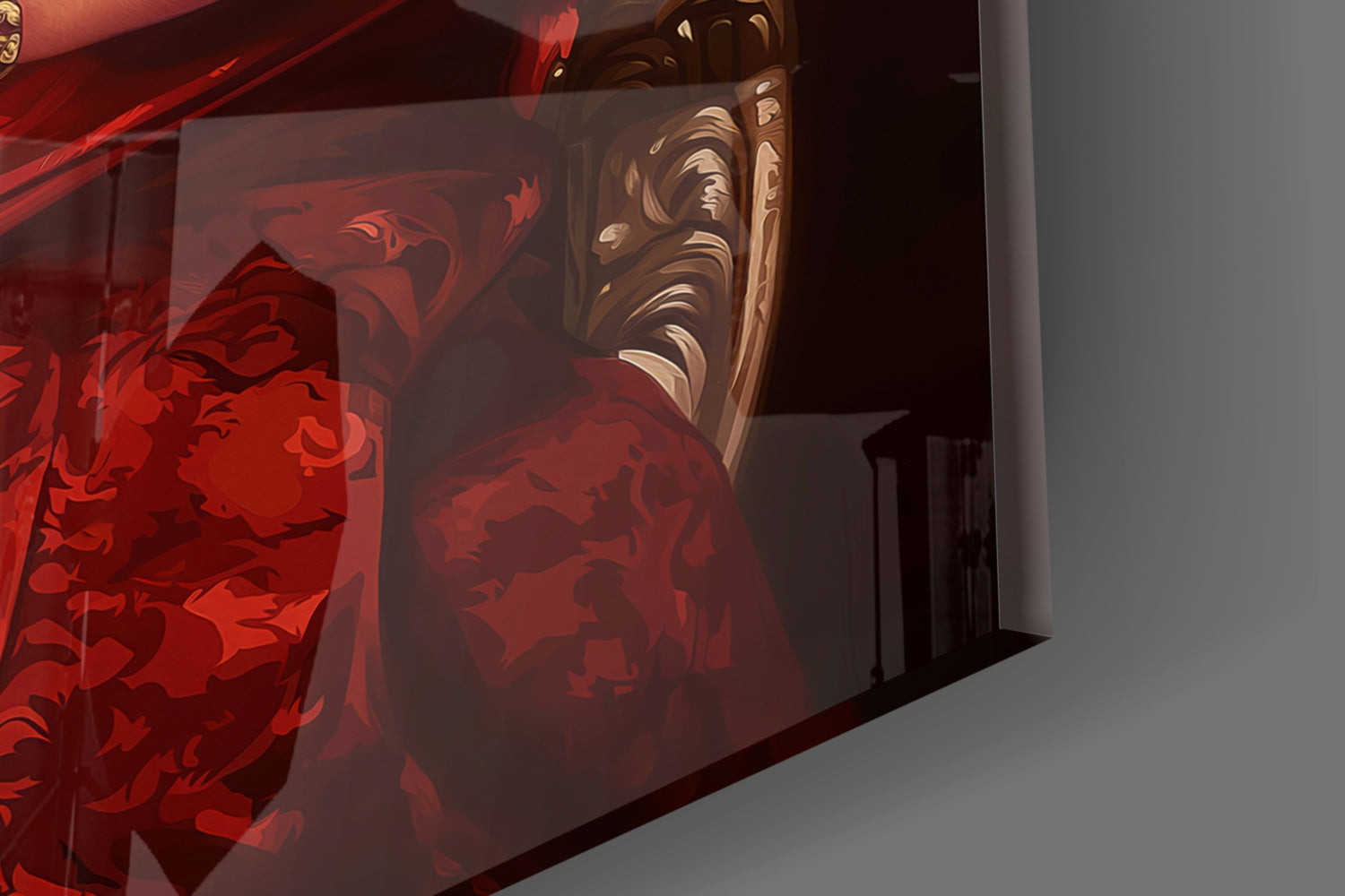 Red glass wall art with ornate gold molding detail displayed at an angle against white wall.