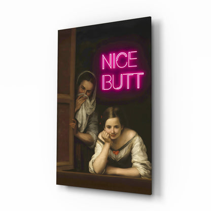Angled view of glass wall art featuring two classical painted figures at a window with bright pink neon "NICE BUTT" text overlay.