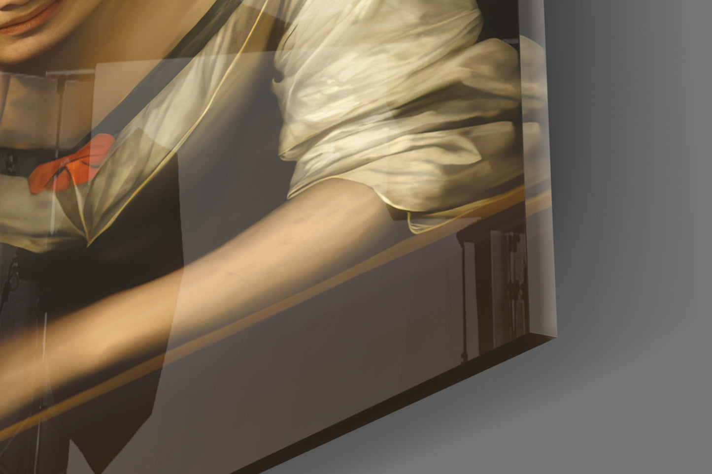 Close-up angled view of glass wall art showing draped cream fabric, bare arm, and red flower detail against dark background.
