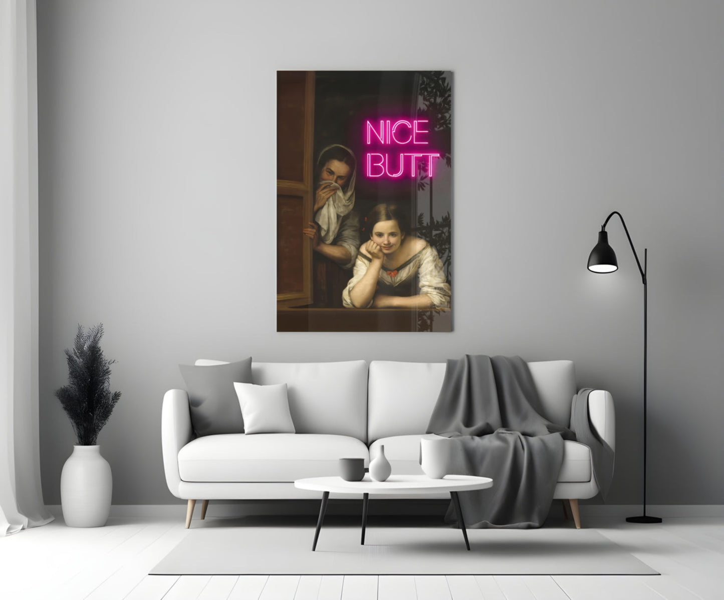 Classical painting of two women in a room with bright pink neon "NICE BUTT" text overlay, displayed above a white sofa in a modern living room.