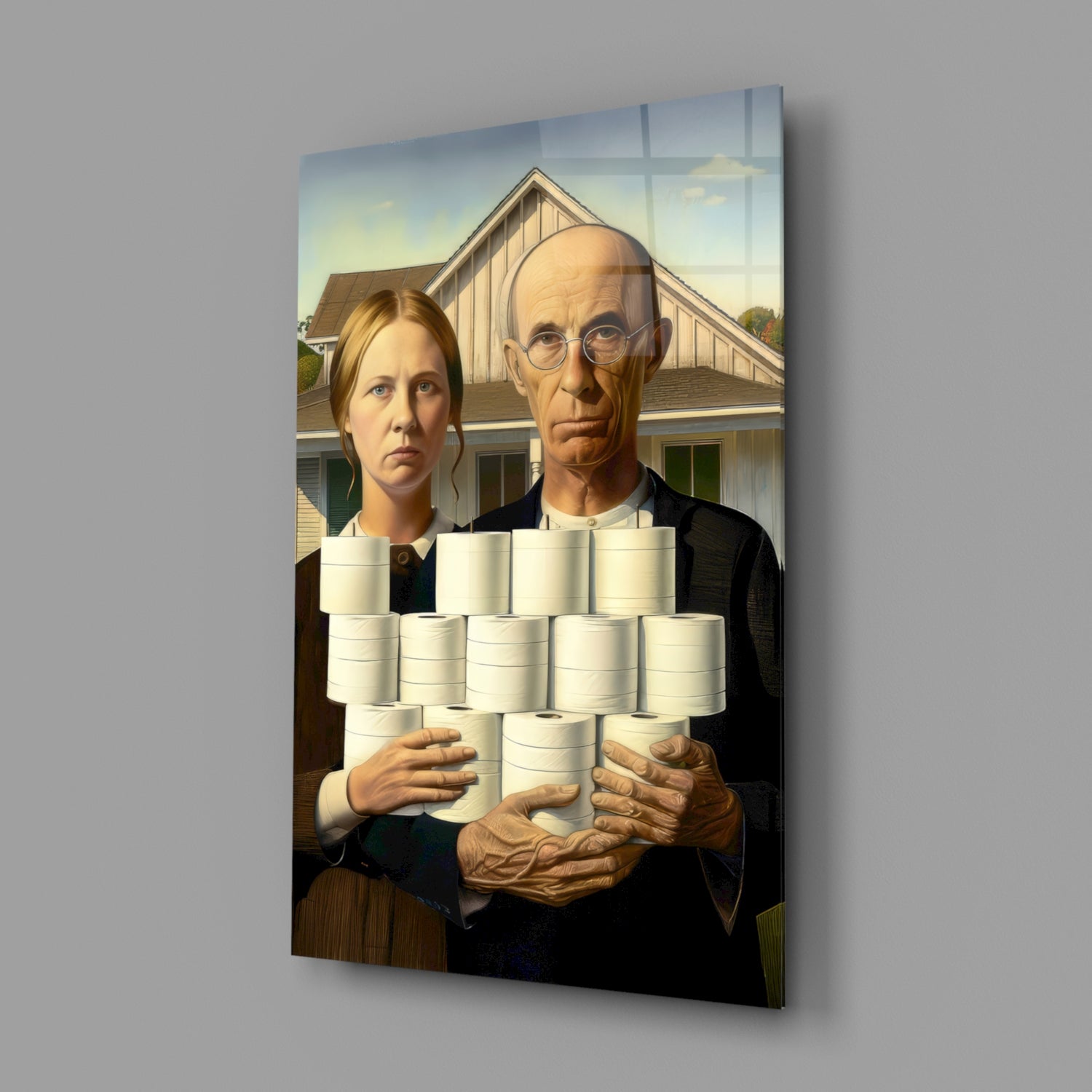 Glass wall art displaying figures holding stacked white cylindrical objects before a farmhouse, angled view showing depth and shadow.