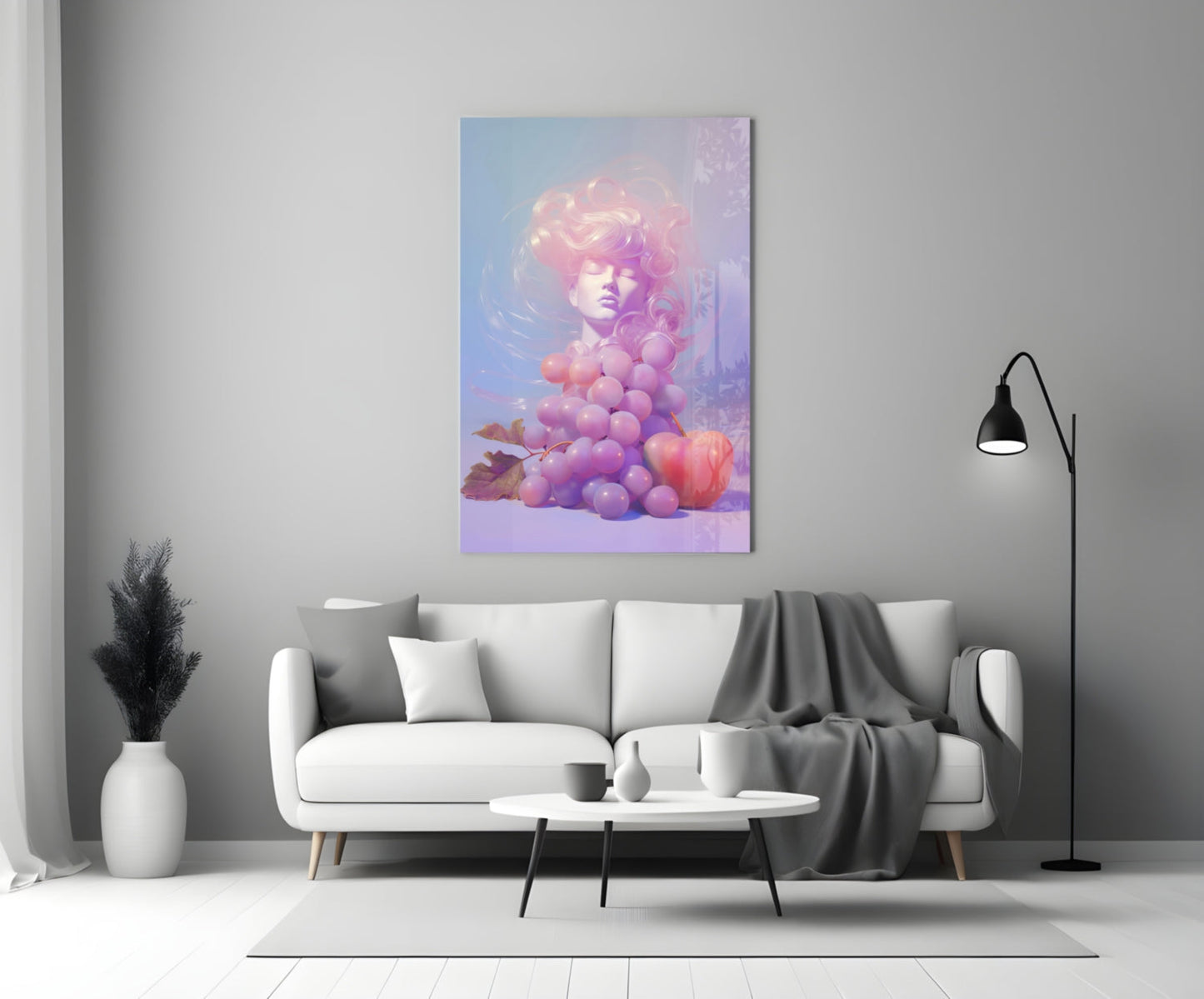 Vertical glass art panel displaying a surreal figure with pink hair surrounded by purple and pink grapes against a blue gradient background, hung above a white sofa.