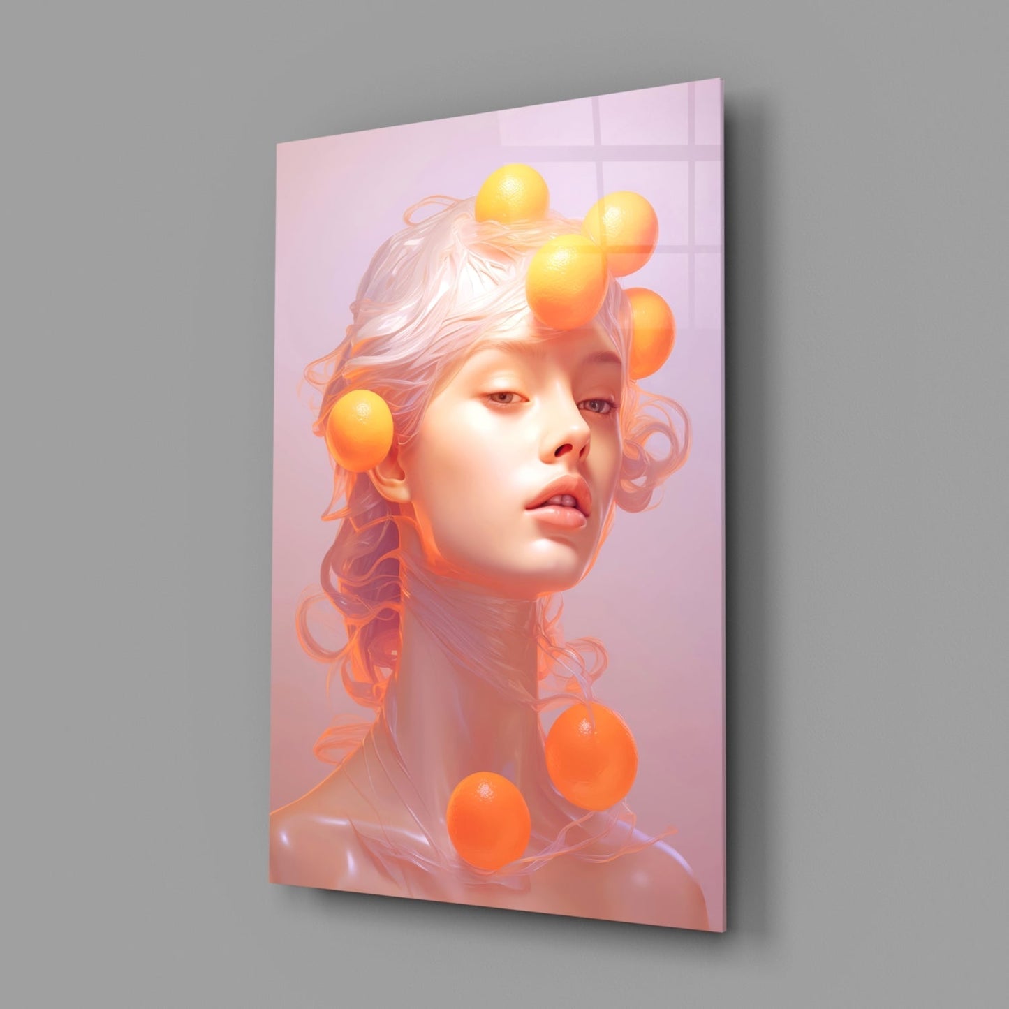 Angled perspective of glass wall art featuring a sculptural face with flowing hair and glowing orange spheres against a pink gradient background.