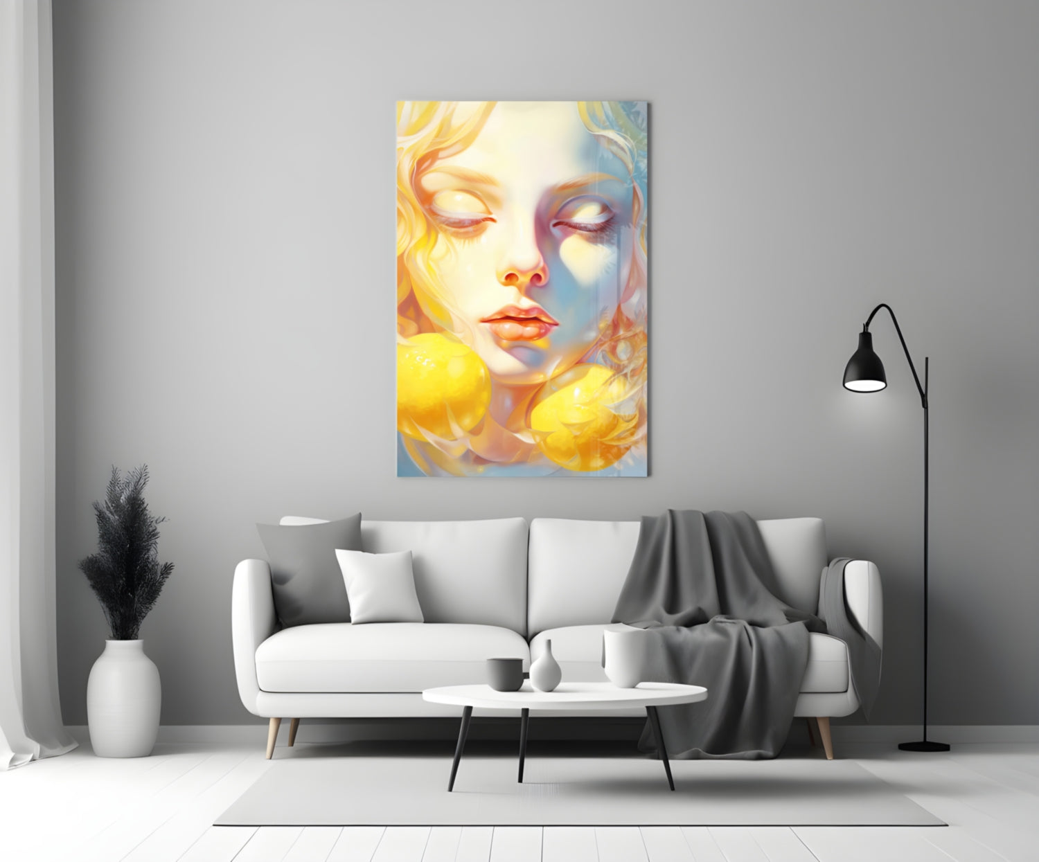 Vibrant glass wall art depicting a serene female face with yellow and blue tones, displayed above a white sofa in a minimalist living room setting.