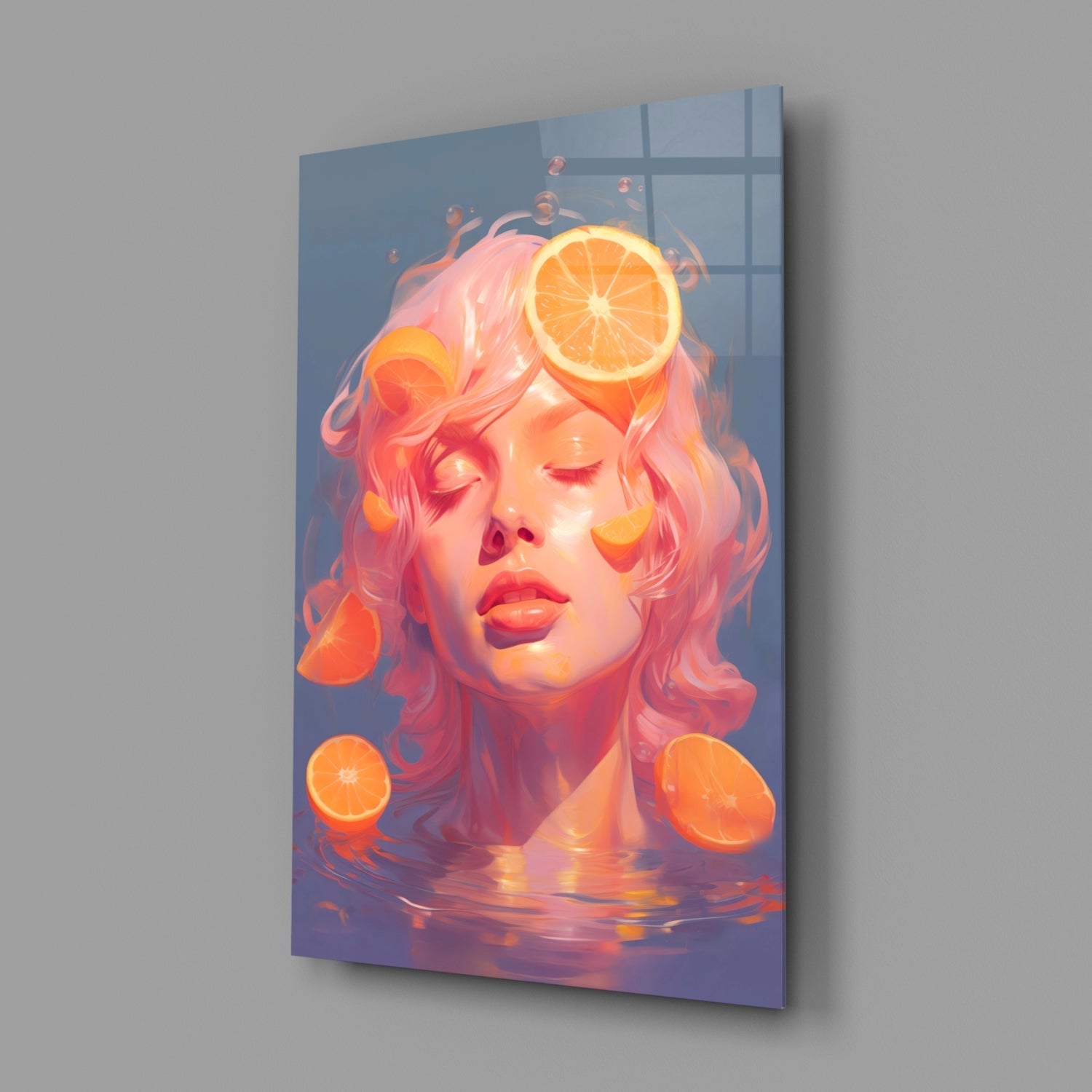 Glass wall art panel mounted on gray wall displaying a stylized portrait with pink hair and orange citrus slices in warm, glowing tones.
